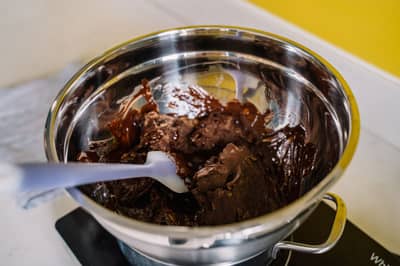 Chocolate melting gently in a bowl set over a pot of simmering water