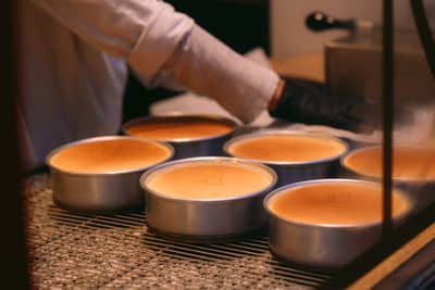 Round cake tins filled with batter ready for the oven