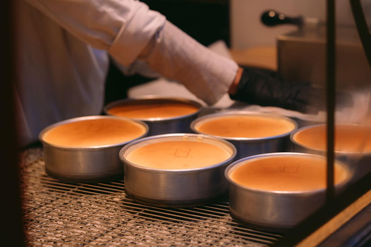 Round cake tins filled with batter ready for the oven