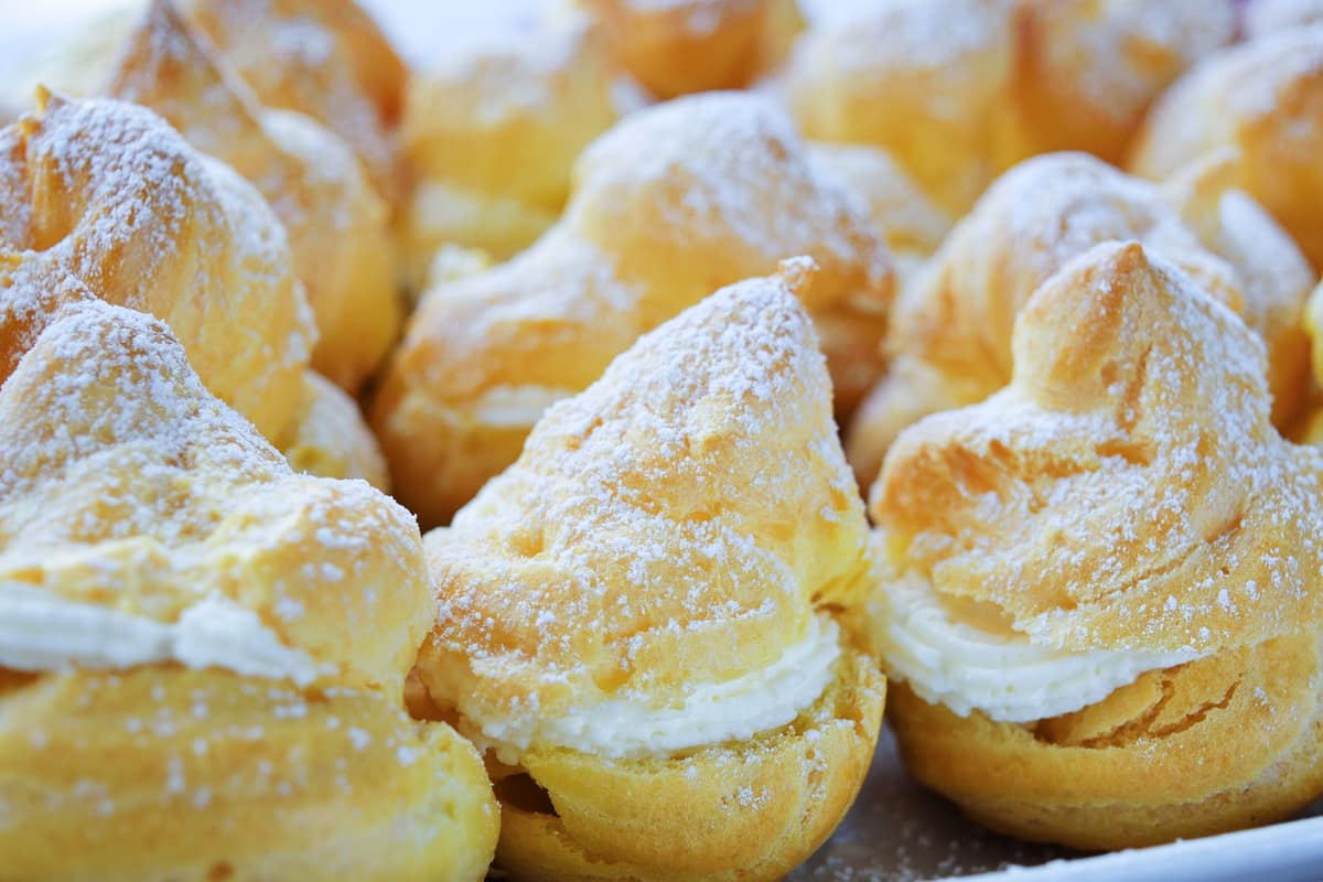 Cream-filled choux puffs dusted with icing sugar