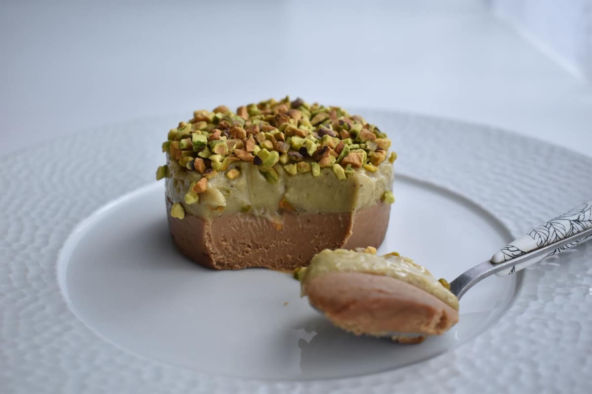 A layered pastry slice finished with piped cremeux