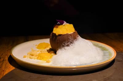 A plated dessert finished with a light culinary foam
