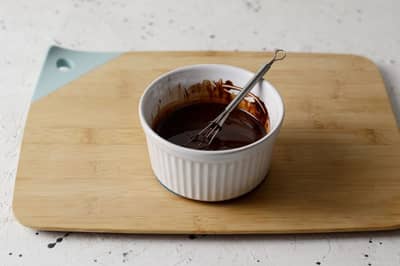 A glossy, smooth chocolate emulsion in a ramekin