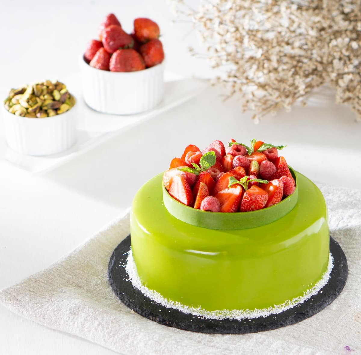 A glossy glazed entremet dome on a plate
