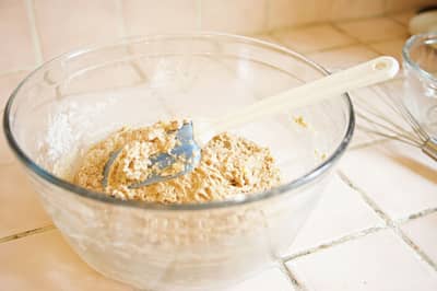 Batter being folded gently with a spatula to keep the air in