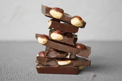 Chunks of hazelnut chocolate with whole roasted hazelnuts
