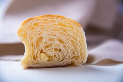 A flaky pastry cross-section showing fine buttery layers