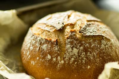 A crusty round loaf with a deep golden-brown Maillard crust
