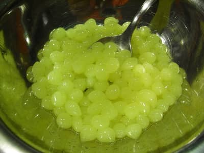 Tiny green spheres made by spherification