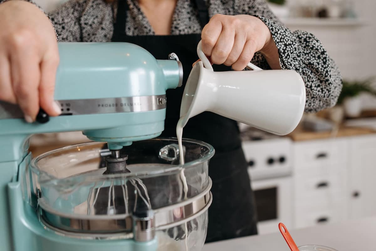 A stand mixer on a kitchen counter ready for creaming
