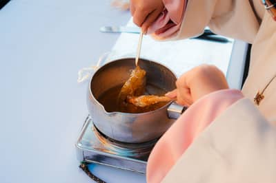 Amber sugar syrup ribboning off a spoon