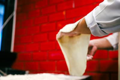 Dough stretched thin enough to pass the windowpane test
